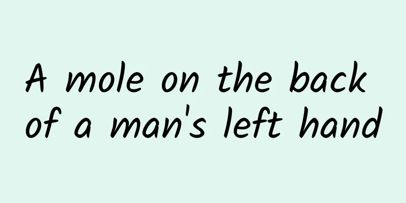 A mole on the back of a man's left hand