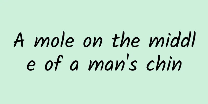 A mole on the middle of a man's chin