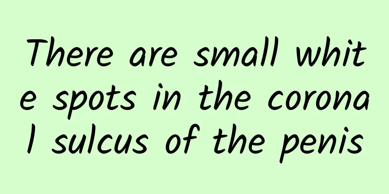 There are small white spots in the coronal sulcus of the penis