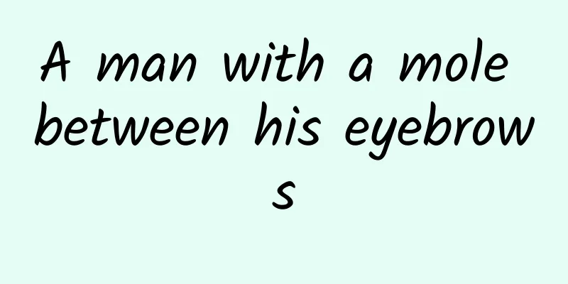 A man with a mole between his eyebrows