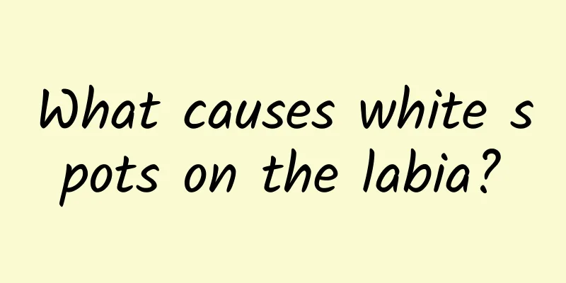 What causes white spots on the labia?