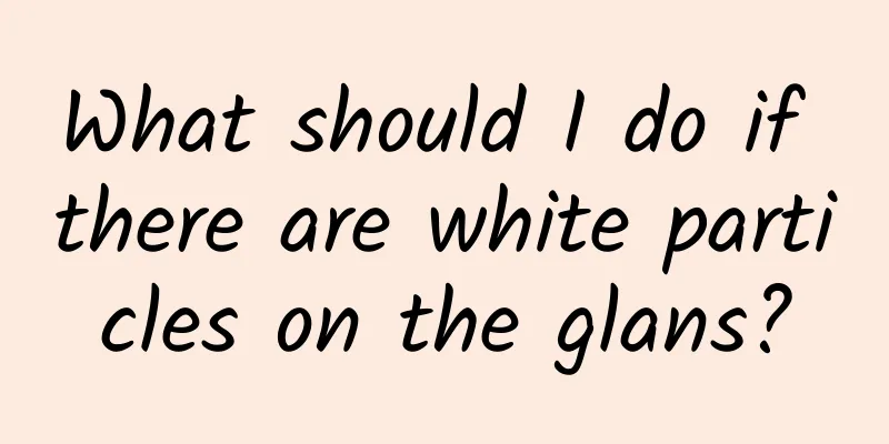 What should I do if there are white particles on the glans?