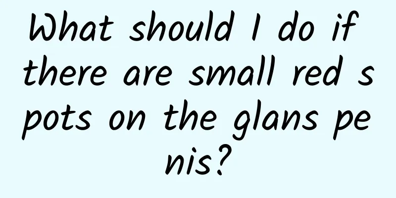 What should I do if there are small red spots on the glans penis?