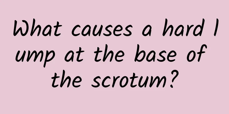 What causes a hard lump at the base of the scrotum?