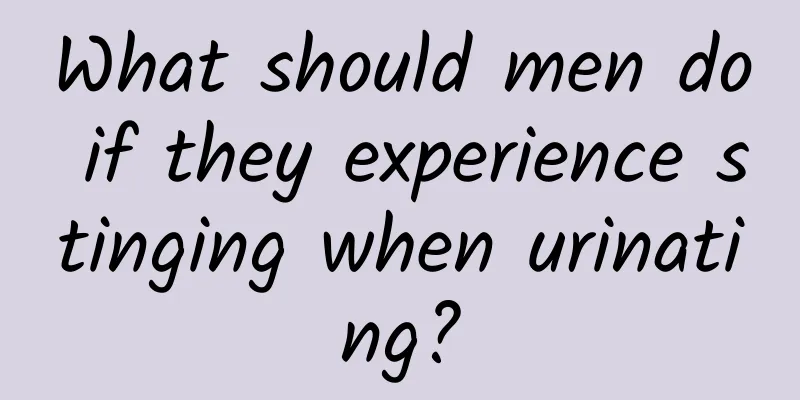 What should men do if they experience stinging when urinating?