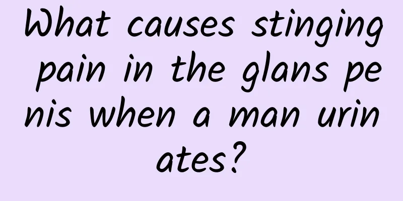 What causes stinging pain in the glans penis when a man urinates?