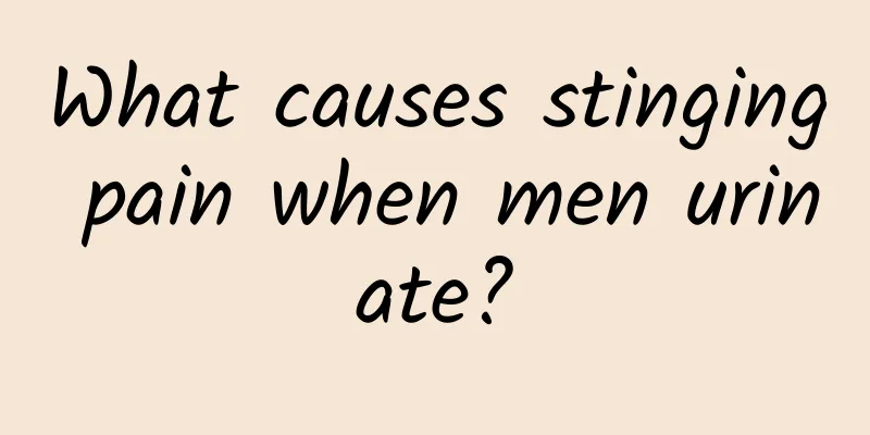 What causes stinging pain when men urinate?